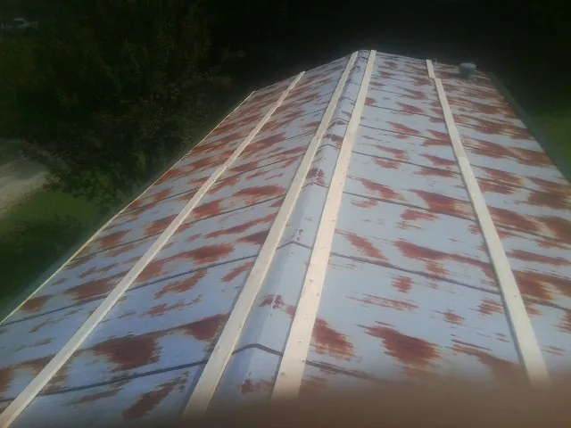 Rusted metal roof panels with new wood purlins before replacement — Storm Damage Roof Repair in Mabel by Roofing Brothers
