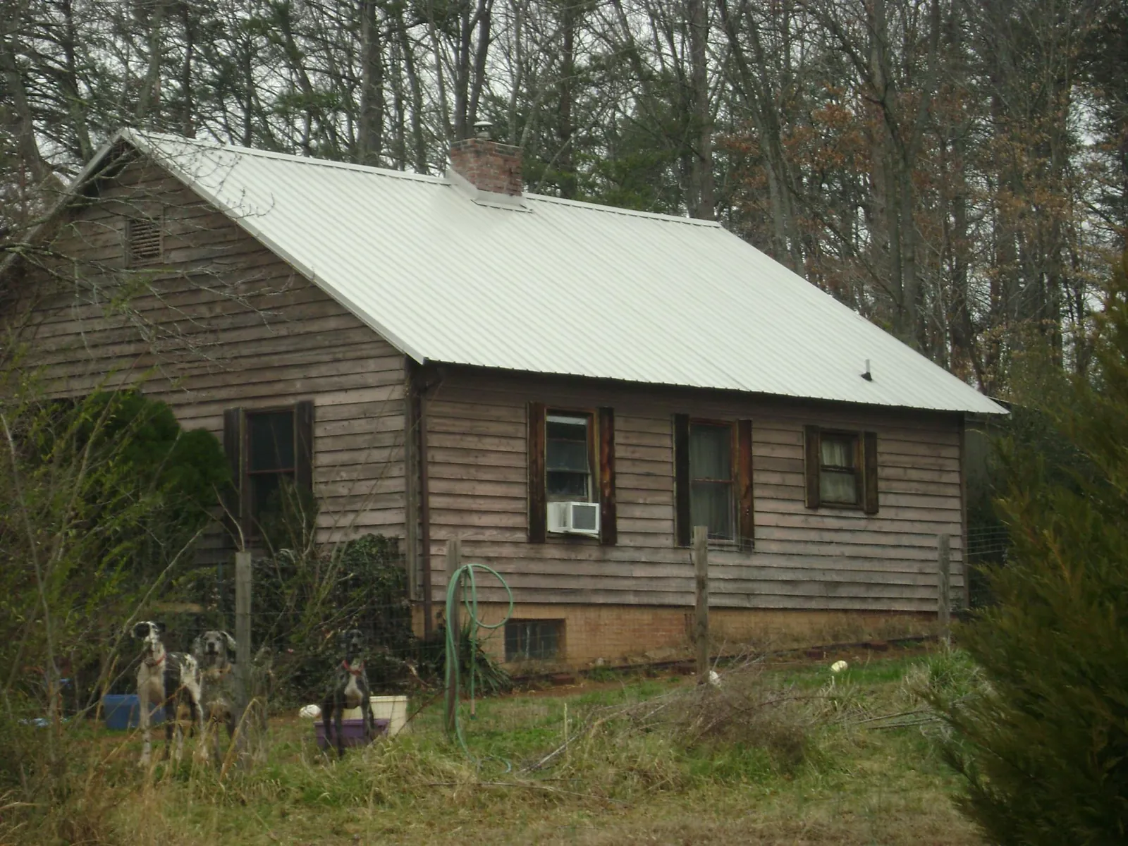 White metal roof on an old wood sided farmhouse, from a Metal Roof Installation job in Mabel